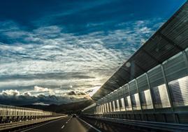 cloudy sky over paved highway