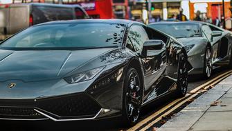 Beautiful, shiny, black Lamborghini Huracan and Aventador, on the street