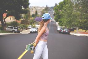 girl with a skateboard on the road