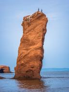 Beautiful rocks in the Bay of Fundy in Canada, at blue sky with white clouds on background