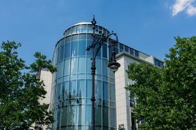 Beautiful, blue, glass building among the green trees