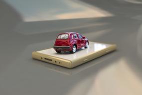 3d model of the red car, on the shiny smartphone, clipart