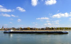 long barge on rhine river near coast