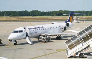White, blue and orange Bombardier Crj700 aircraft of Lufthansa Regional in the airport