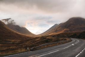 empty asphalt highway in foggy mountains