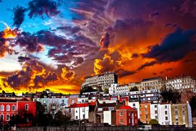 clouds in the sky during sunset over city houses