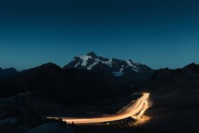 light from night traffic on a mountain road