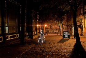 woman walking down the street at night