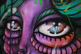 Beautiful and colorful graffiti with the face, with the eyes, on the wall in London, England