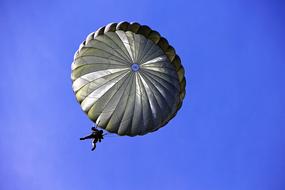 military man on a parachute in the sky