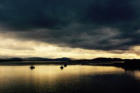 sailboats on the lake in dark twilight