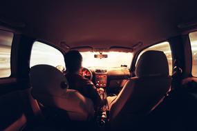 view of the driver behind the wheel of the car