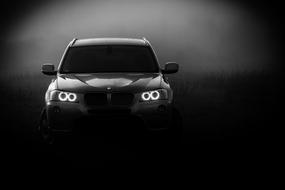 Black and white photo the BMW x3 car at black and white background