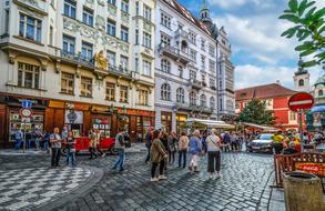 tourists walking down the street in Prague