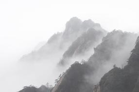 Mist over forested mountains, china, huangshan