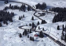 panoramic view of a winding road in an alpine landscape