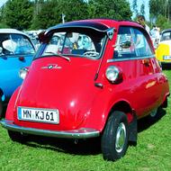 Red BMW Isetta among other colorful cars on the green grass