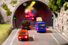 Figures of the colorful cars in the tunnel, with the lights