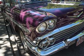 Close-up of the shiny, beautiful, retro, purple Chevrolet auto on the street