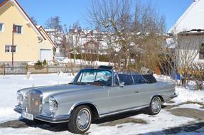 gray car in the yard on a sunny day in winter