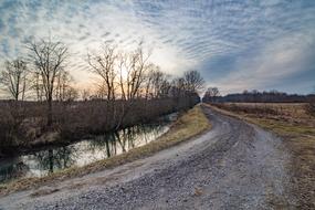 curved road with gravel near the river