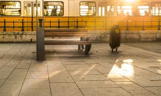 Yellow and white tram, on the beautiful tram station, in light