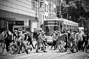 Black and white photo with the train near the people in DÃ¼sseldorf, Germany