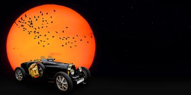 drawn retro car and a flock of birds on the background of an orange moon