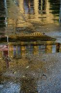 house is reflected in a puddle