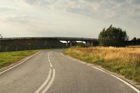 bridge over winding road in countryside