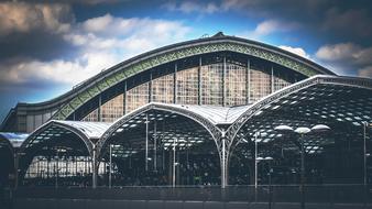 Railway station building with the concourse, under the blue sky with clouds