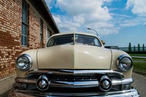 a ford car stands near a brick building