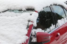 Red car in the beautiful, white snow, in winter