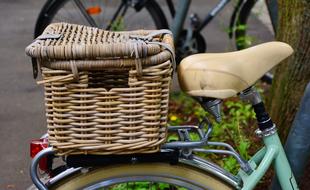 old bicycle with a wicker basket on a blurred background