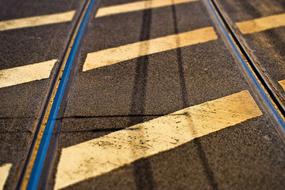 Road mark among the rails in shadow and light