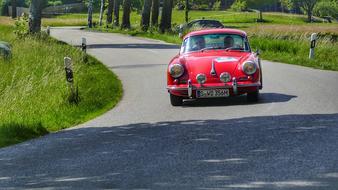 red car driving on the road