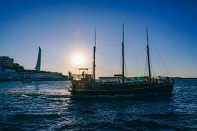 Beautiful waterscape with boat on the water at colorful sunset on background