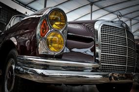 Beautiful, shiny, vintage, classic Mercedes Benz car with the headlights