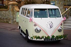 Beautiful, white birdal Volkswagen car with colorful decorations