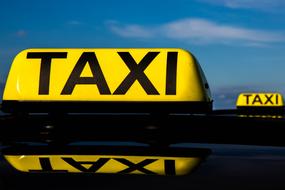 taxi as a sign on the roof of a car