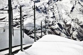 Beautiful landscape with the snowy railway on the mountain