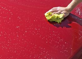 hand washing a red car