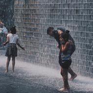 People, walking on the street, near the wall, in the rain