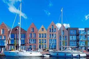 ships on the water near modern buildings