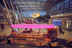 Beautiful interior of the airport with colorful lights and people in DÃ¼sseldorf, Germany