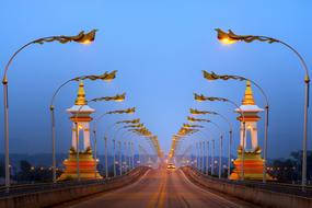 Beautiful landscape of the bridge with colorful lights and cars, in the evening