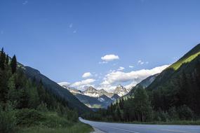 Highway to scenic Mountains under blue sky