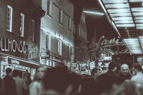 crowd on a night city street in monochrome