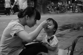 Black and white photo of the mother with the child, on the road in Vietnam