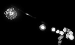 black and white photo of a street lamp in the dark